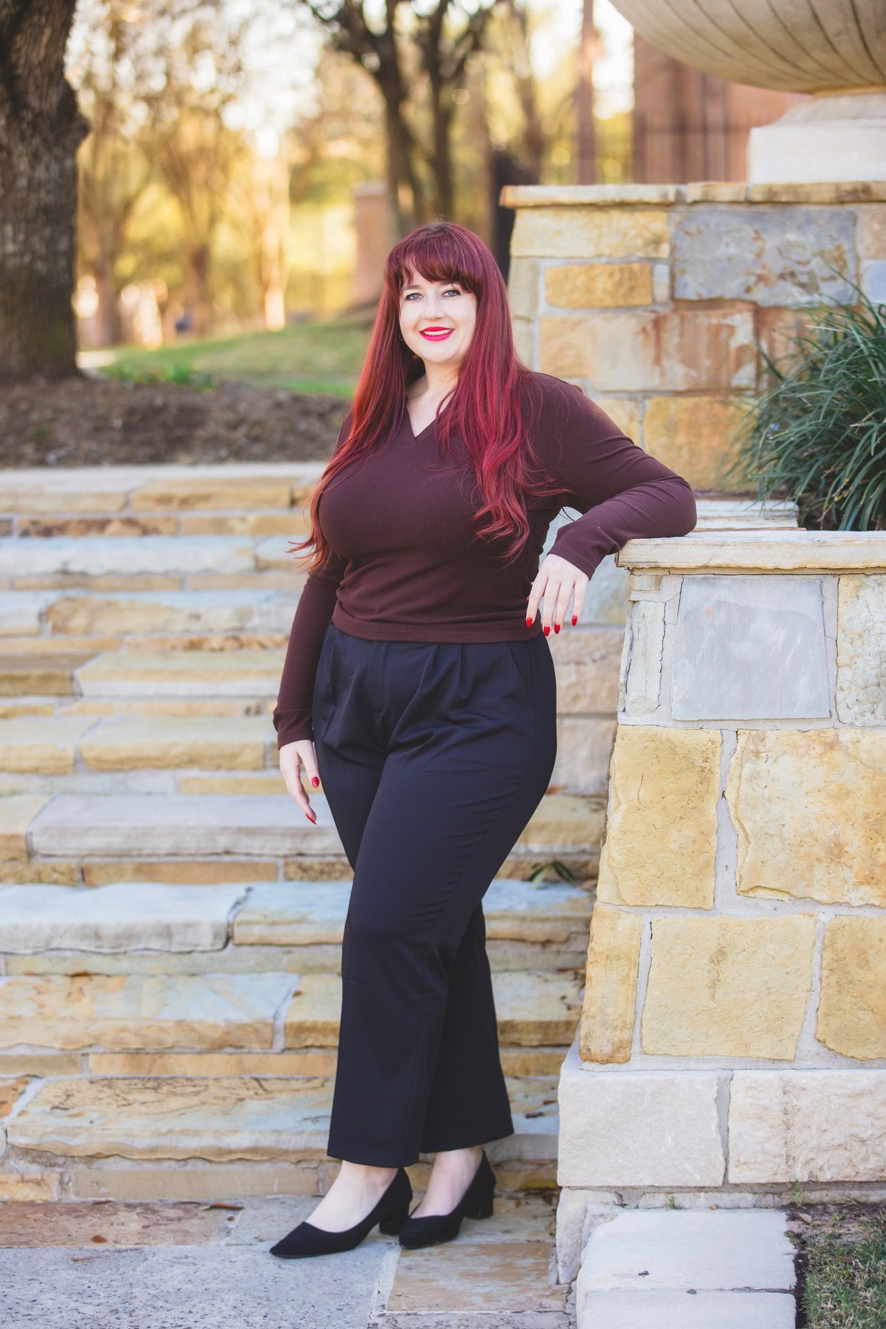 Jessica Pitacaithly standing beside stone steps and a stone wall.