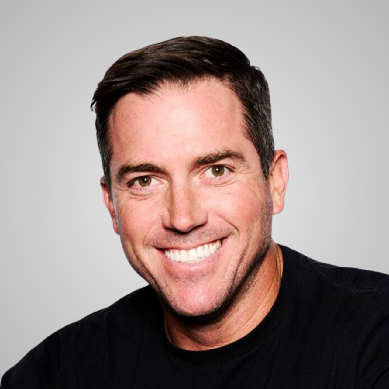 Sean Herrero smiling in a black shirt against a light gray background.