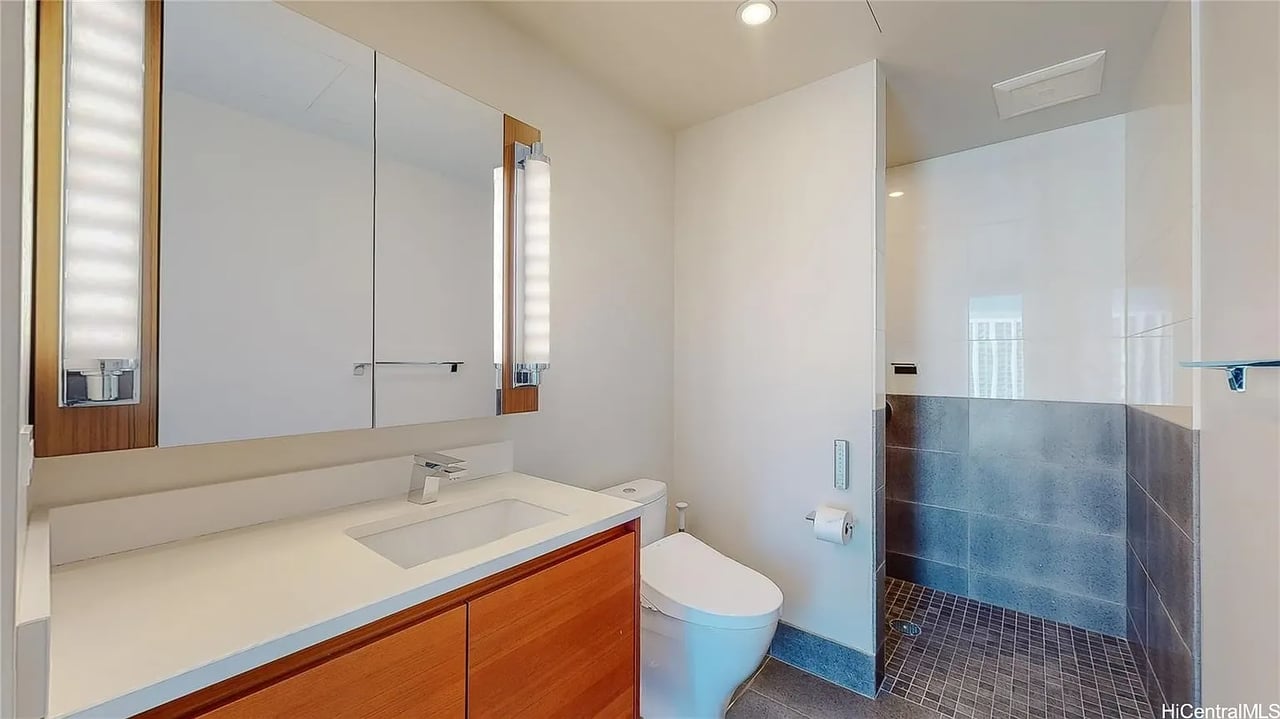 Modern bathroom with a wood-front vanity and tiled walk-in shower.