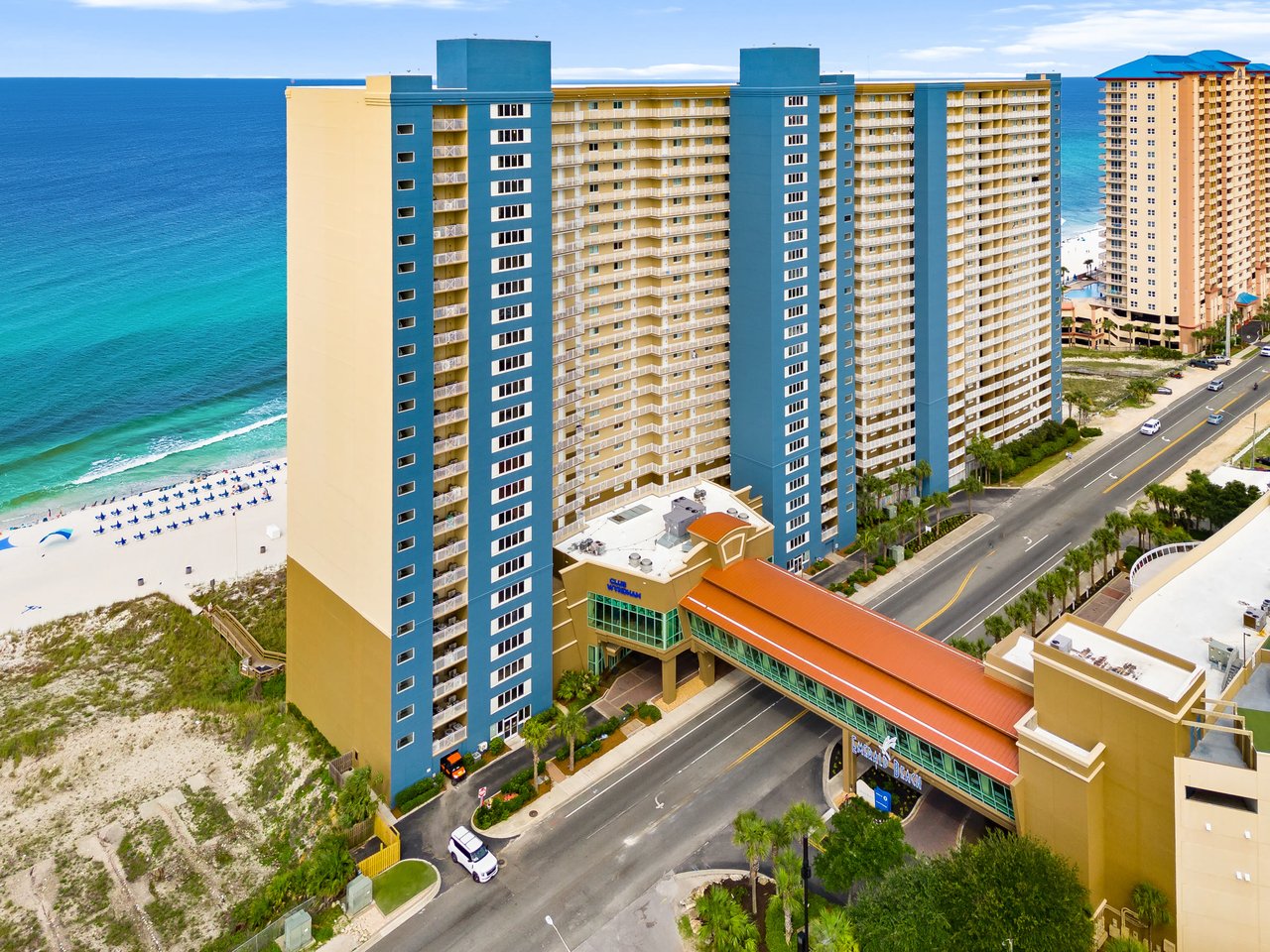 ndo tower with a pedestrian bridge over Front Beach Road in Panama City Beach