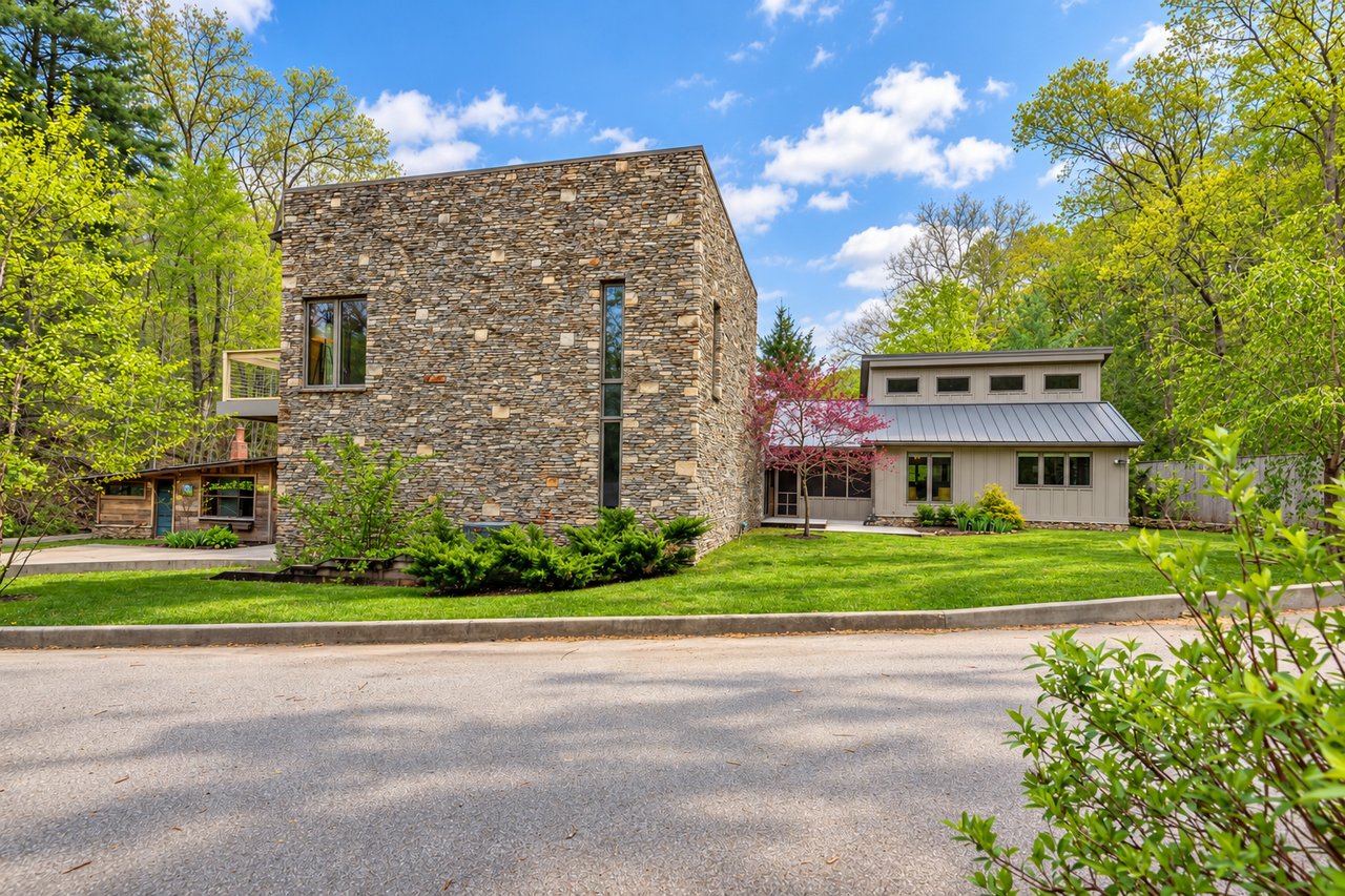 Modern home with stone and siding in the woods
