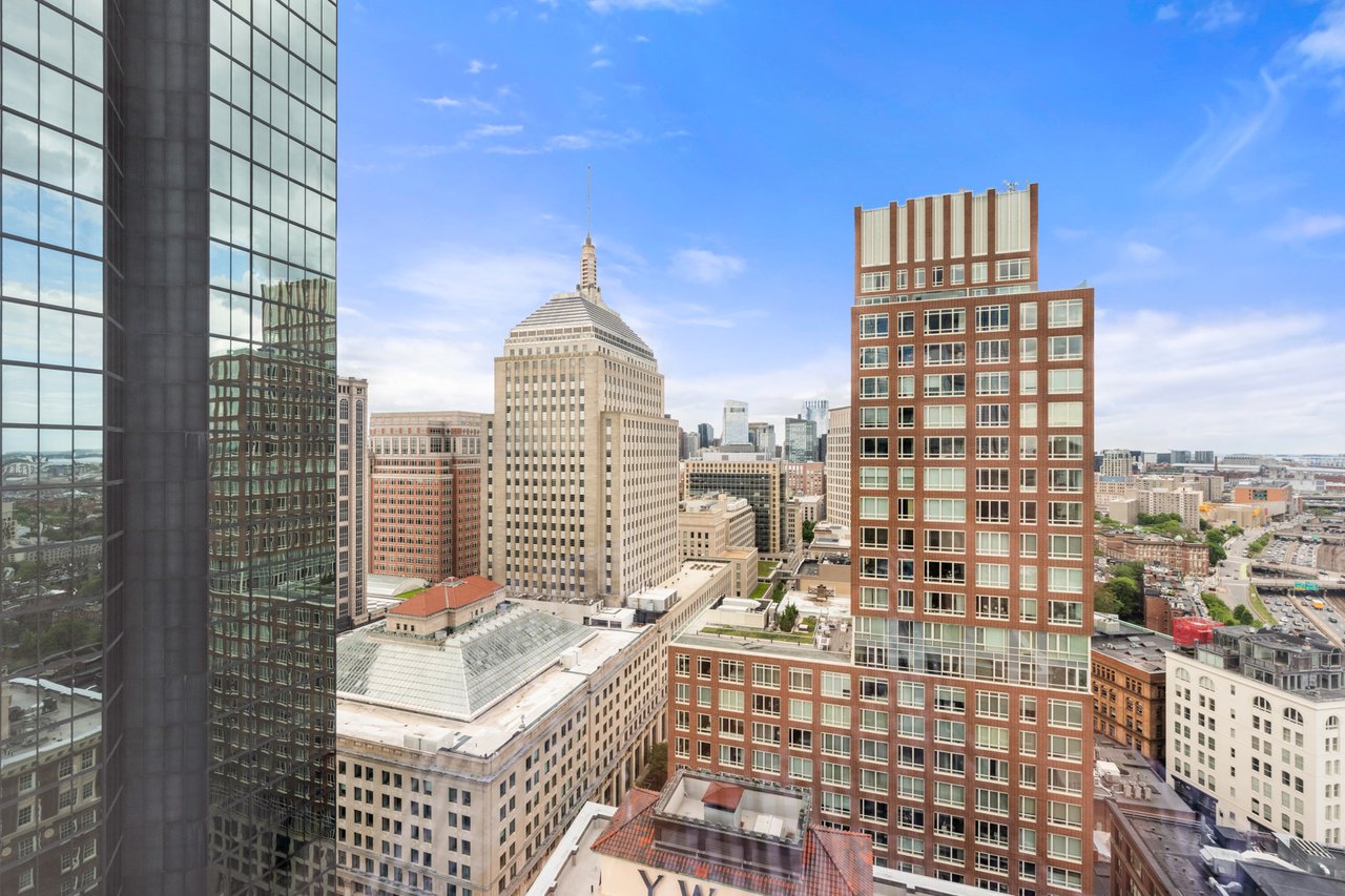 Downtown Boston skyline with a distinctive stepped-roof tower and surrounding high-rises.