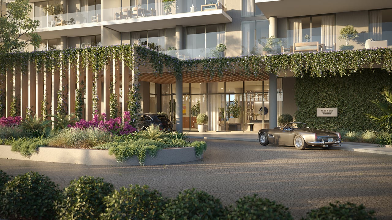 Rosewood Residences entrance with landscaped terraces and a vintage convertible.