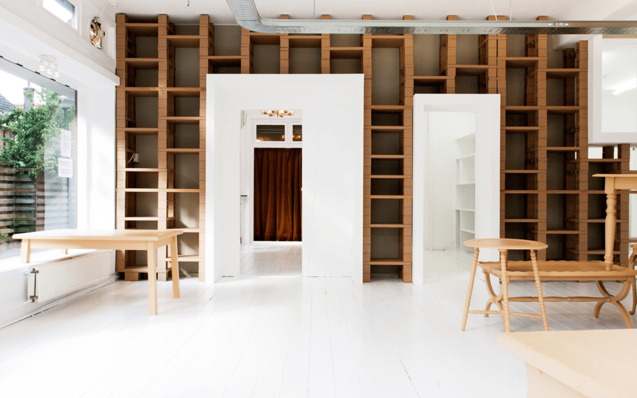  A brightly lit room with white floors and walls features two large.