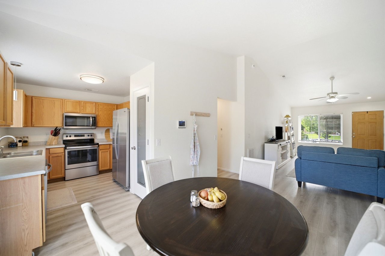 Kitchen with stainless steel appliances open to the dining and living areas