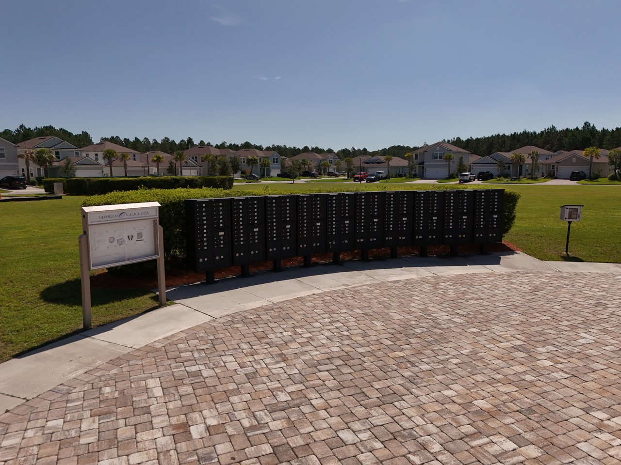 Community mailboxes and Silverleaf Village HOA sign in front of suburban homes.