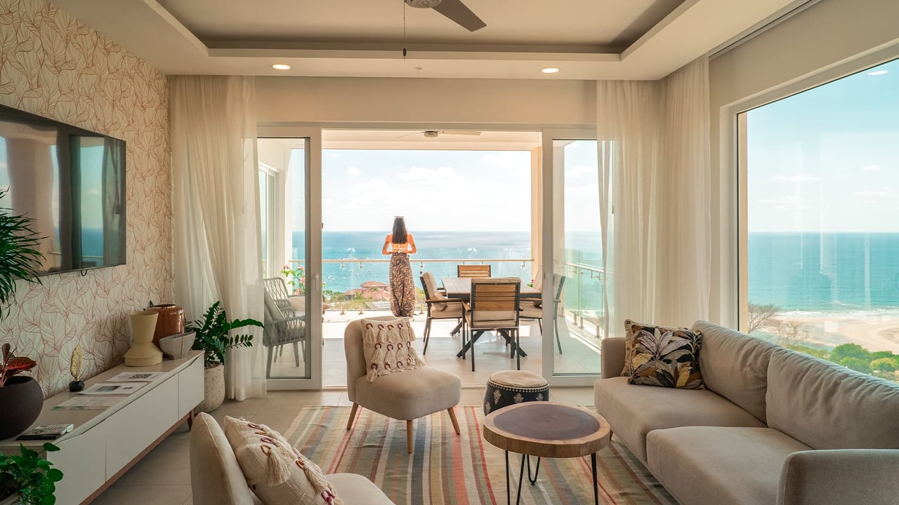 Ocean view condo for sale at La Vista in Tamarindo, Costa Rica, with an open-plan living room opening onto a terrace overlooking Tamarindo Bay