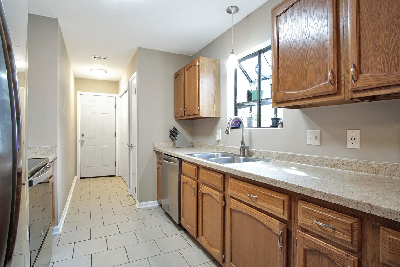 A modern kitchen featuring a sink, stove, and refrigerator, showcasing a functional and organized cooking space.