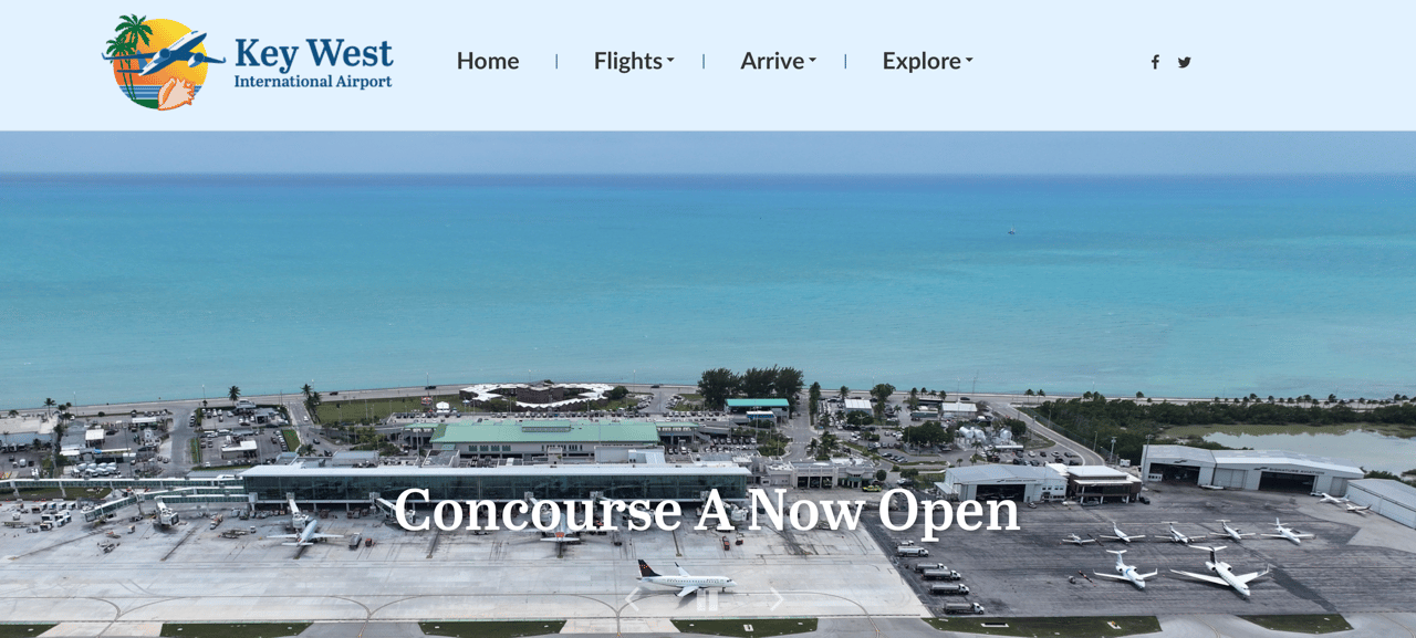 Aerial view of Key West International Airport beside turquoise water, with aircraft at the gates.