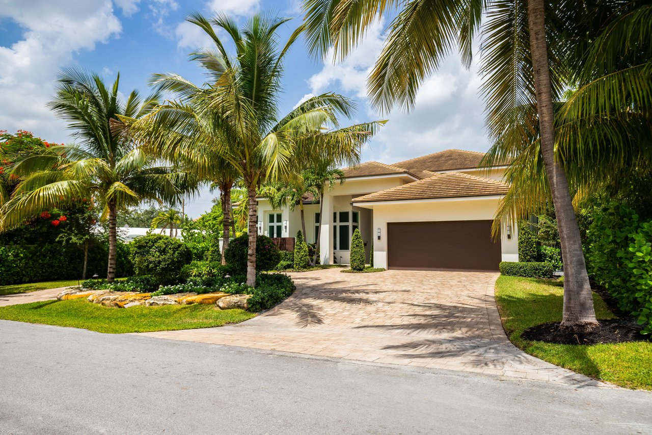 Front view of a modern two-story house with a landscaped yard for sale in Tampa, FL