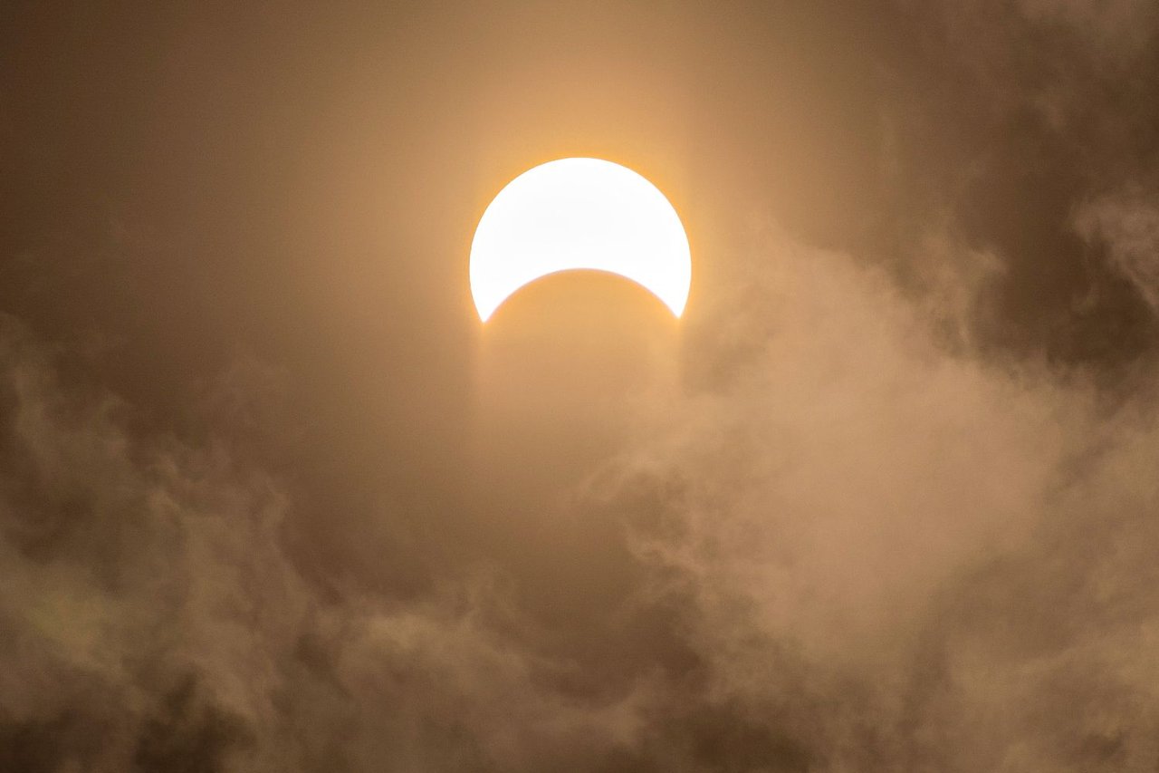 Moon partially covering the Sun during a solar eclipse