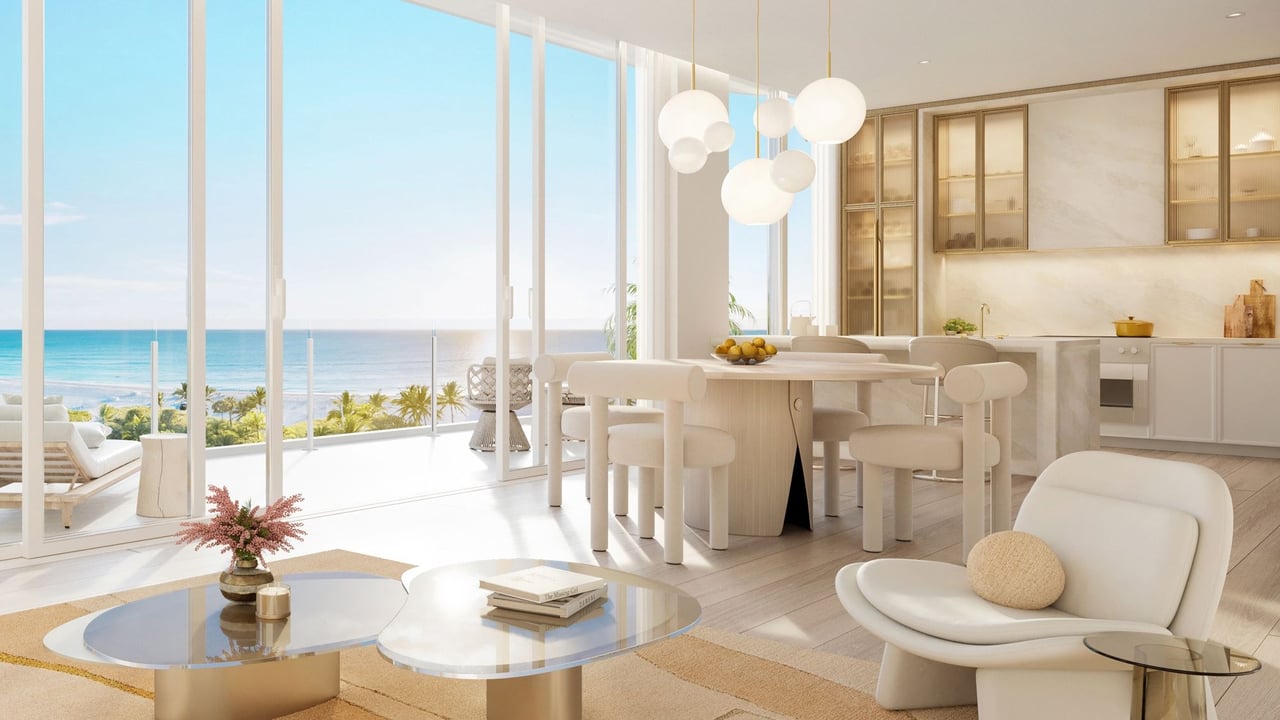 Luxury condo living room and kitchen with floor-to-ceiling windows overlooking the ocean.