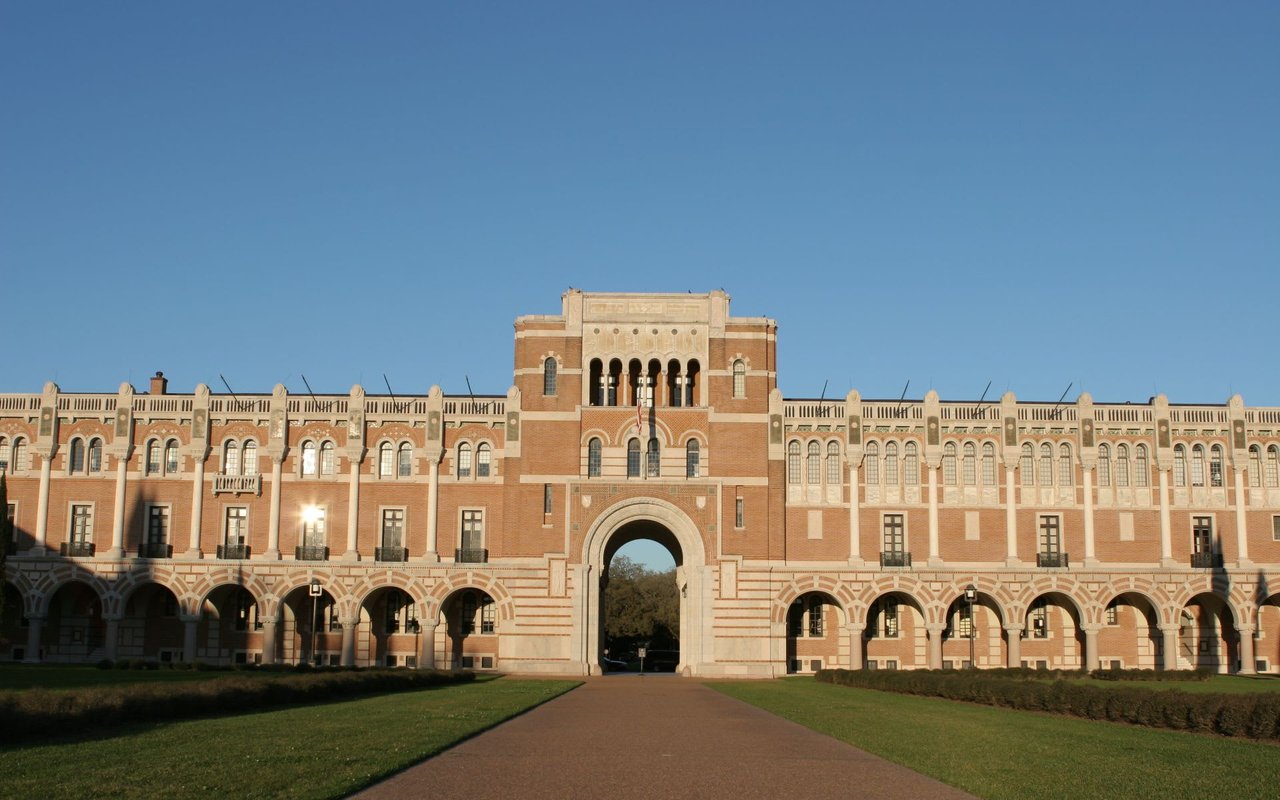 A large brick building with a large archway in front in Rice Houston