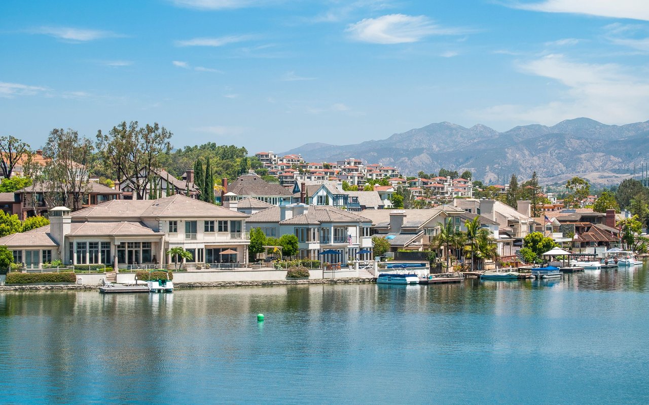 Mission Viejo waterfront homes and boats with mountains in the distance.
