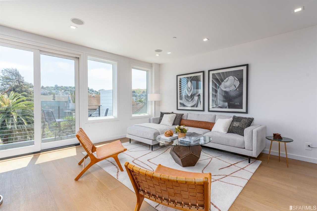 Spacious living room with sectional sofa and large windows
