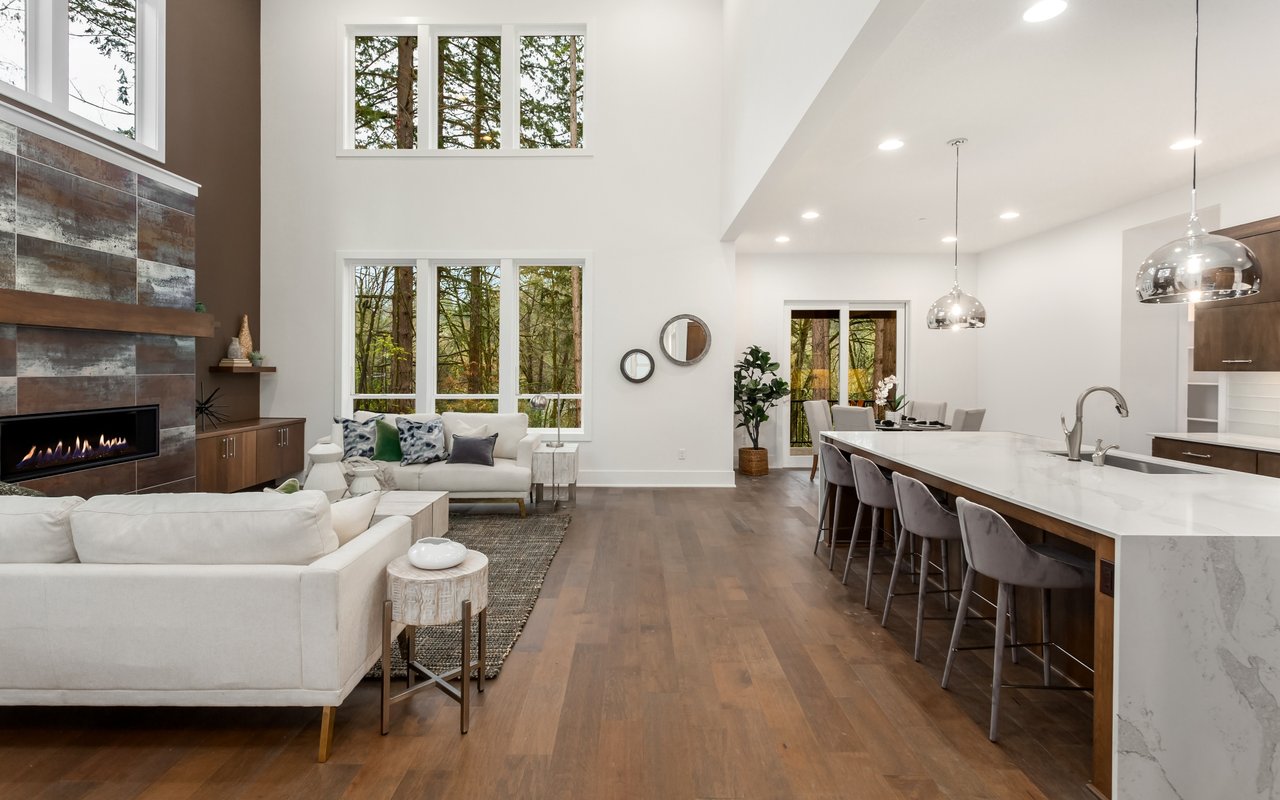 Spacious modern living room and open kitchen in a Murrieta CA home representing real estate property valuation.
