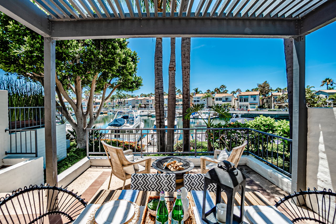 Patio view from Spinnaker Coves townhome overlooking boats and waterfront channel on Alamitos Bay in Long Beach