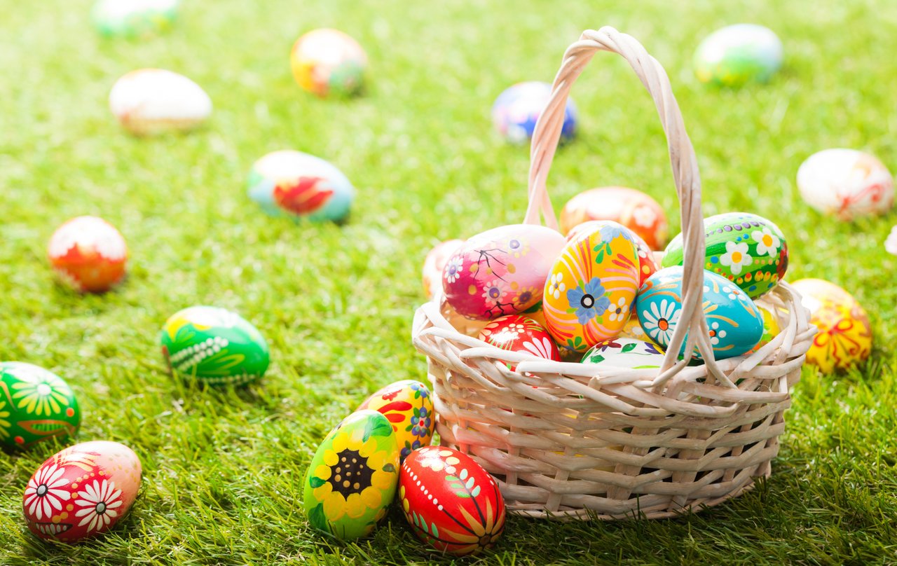 Colorful Easter egg basket in a grassy park, symbolizing family-friendly spring fun in Denver