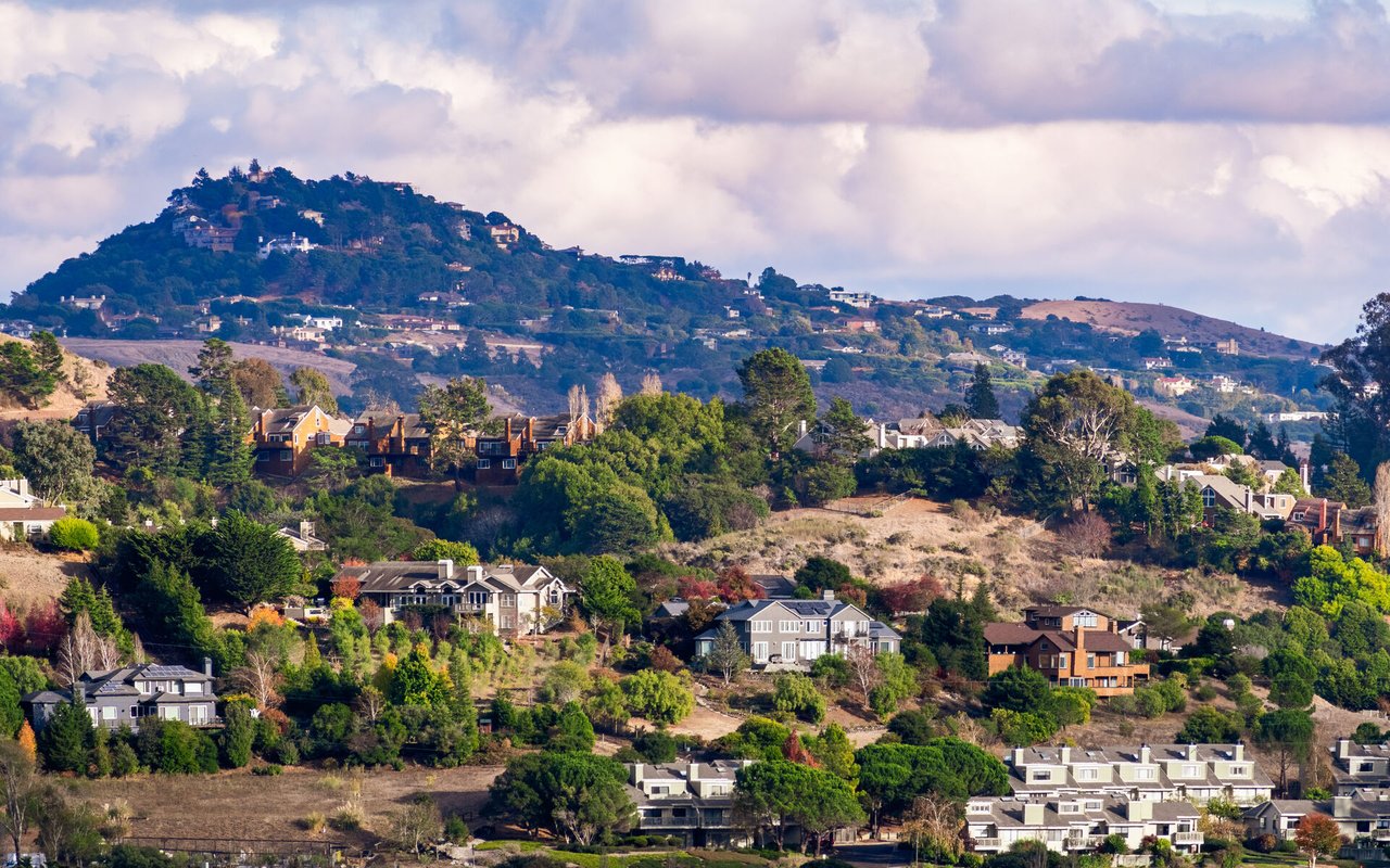 Hillside homes in Mill Valley beneath a cloud-filled sky.