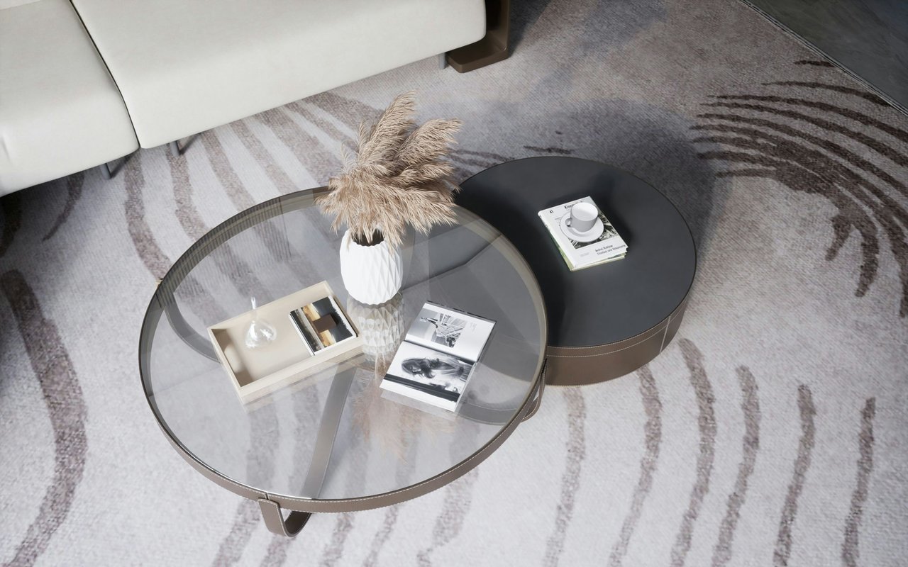 Living room with round coffee tables, a white sofa, and a patterned rug.