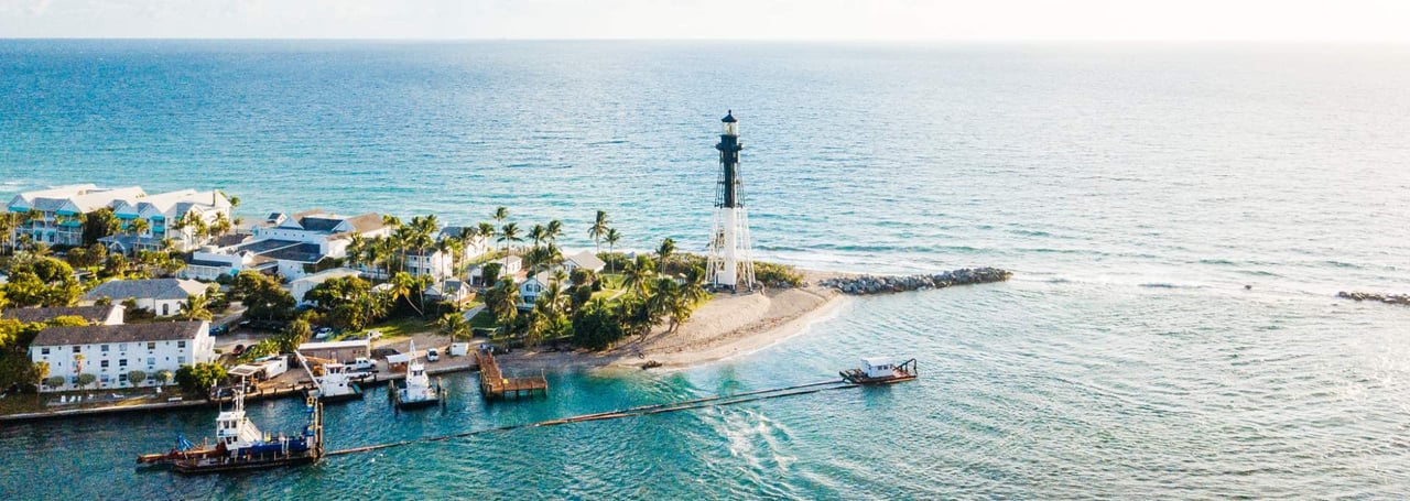 Aerial view of the Hillsboro Inlet Lighthouse on the coast of Hillsboro Beach, Florida.