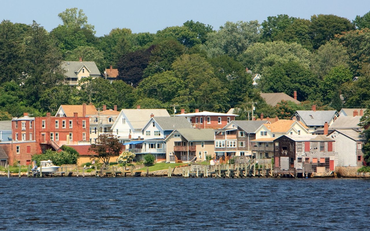 Groton waterfront neighborhood with homes and docks lining the shore.