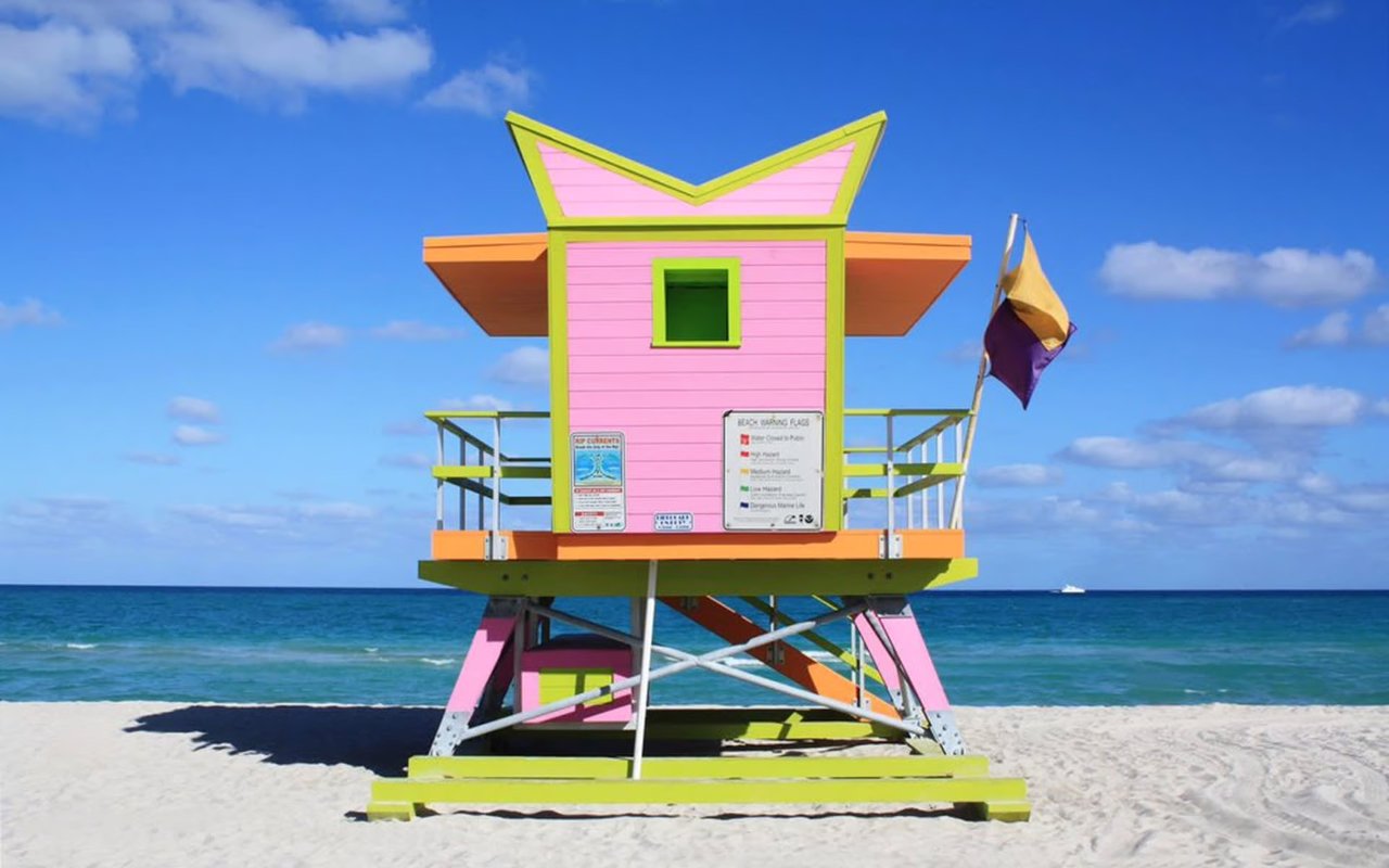 Oceanfront view of Miami Beach Florida with luxury condos, palm-lined streets, and upscale beachfront living