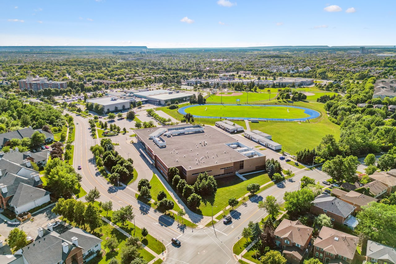 Prestigious Glen Abbey living with a backyard made for summer