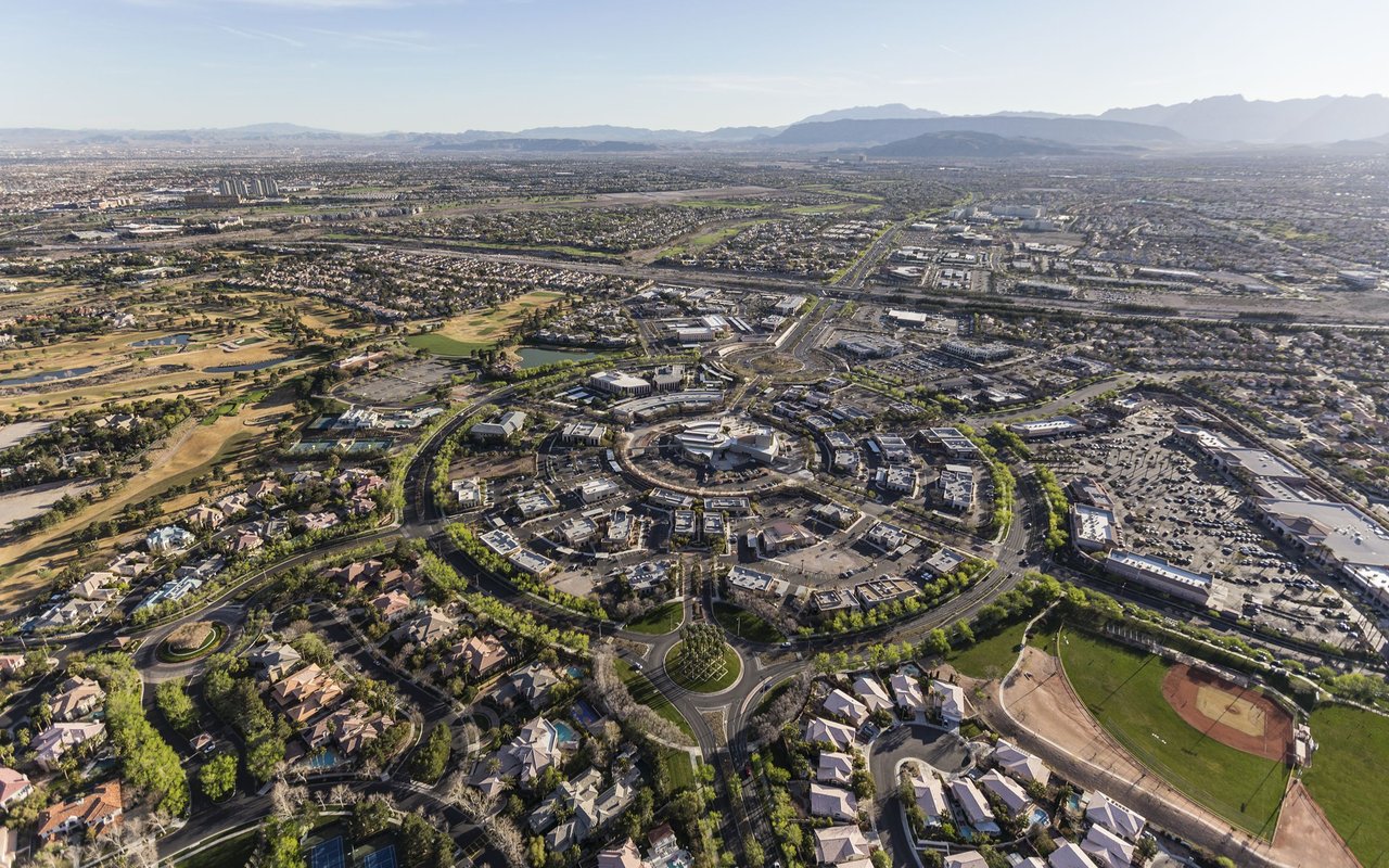 Aerial view of Downtown Summerlin, surrounded by neighborhoods with mountains in the distance.