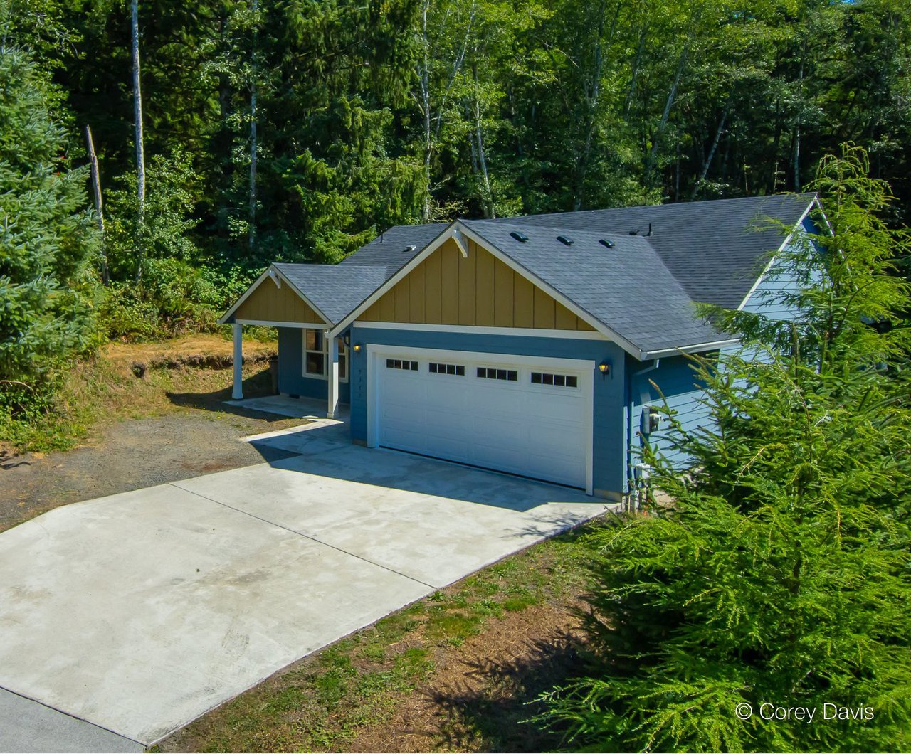 Sold single-level Neahkahnie home at 9370 DeWolf Rd represented by Meadow Davis of Home + Sea Realty with forest views and covered patio