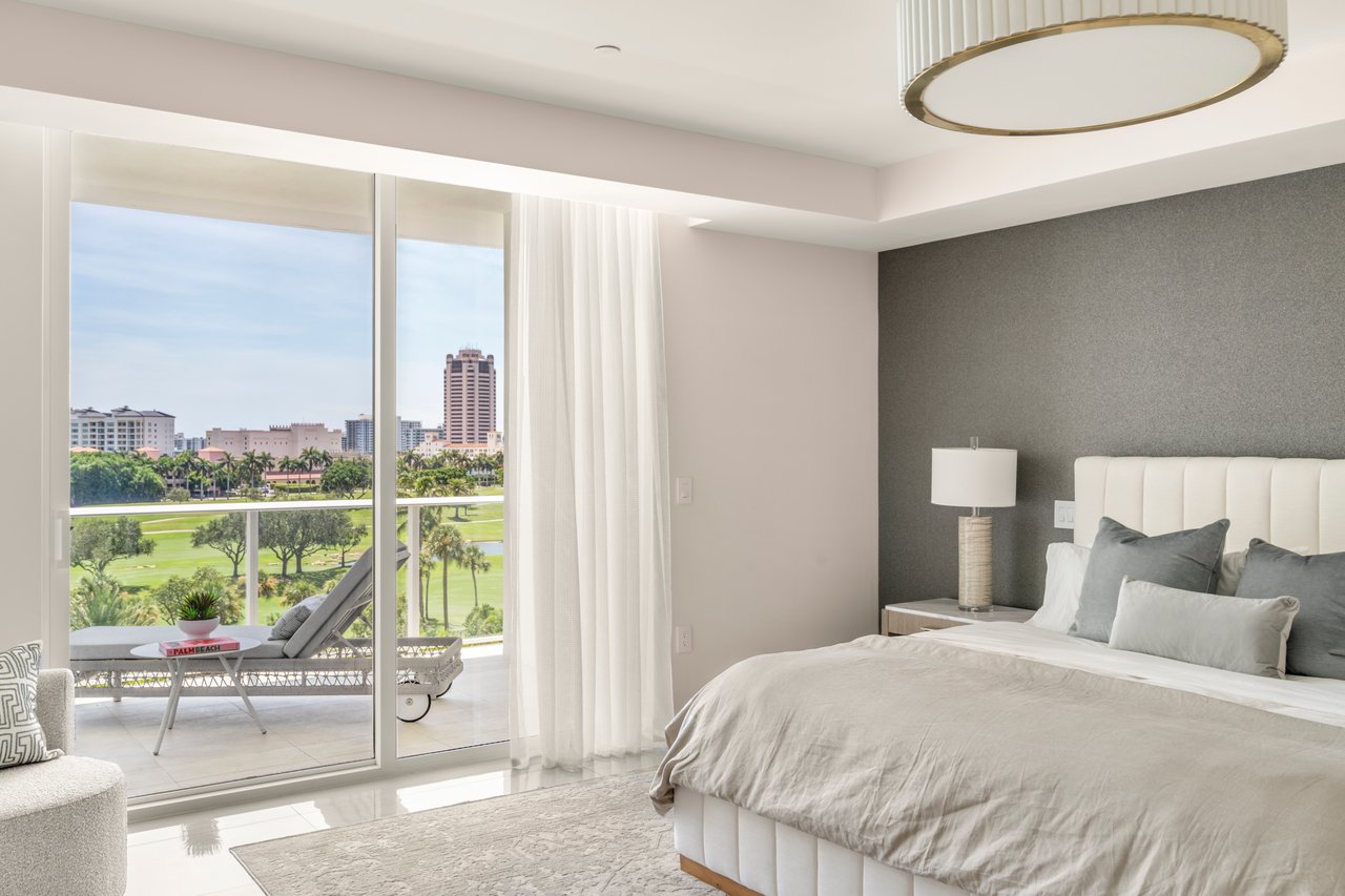 ALINA Residences bedroom in Boca Raton with a balcony, golf-course views and circular ceiling light.
