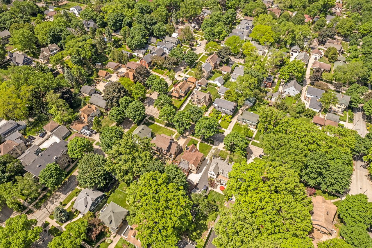 Aerial view of Wauwatosa, Wisconsin, featuring residential homes, tree-lined streets, and greenery