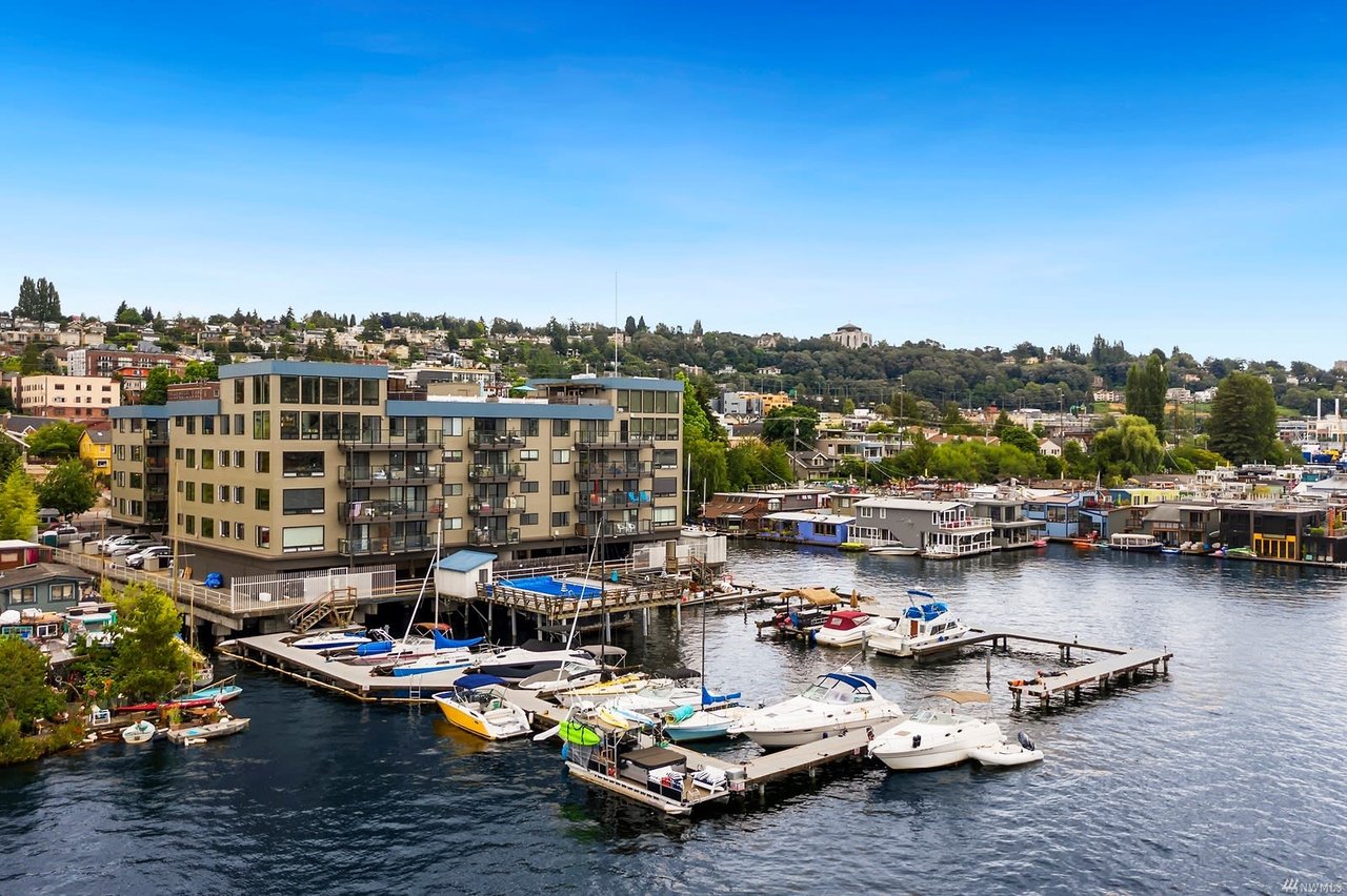 Chic waterfront condos with bustling marina, encapsulating luxury living with a dynamic view.