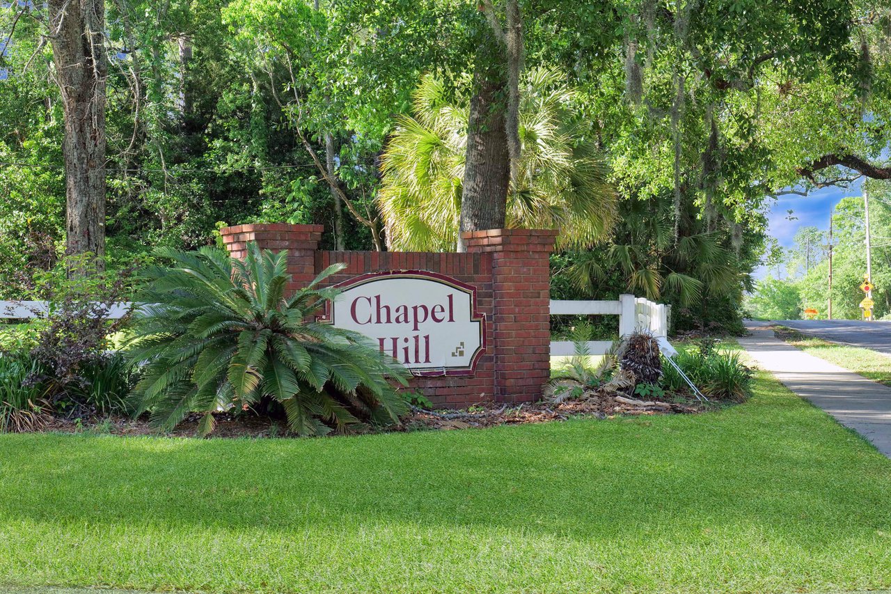 A ground-level view of the entrance sign for "Chapel Hill," marking the entrance to the community.