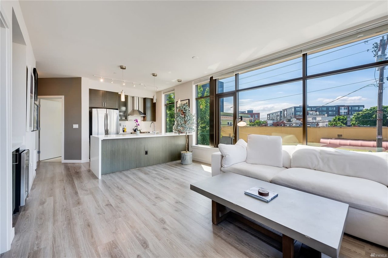 Spacious condo living area with natural light, blending modern design with comfortable living.