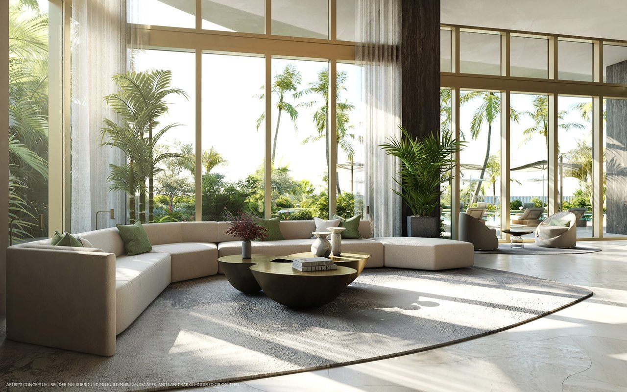 Furnished lounge with a curved cream sectional and floor-to-ceiling windows overlooking palms and a pool.