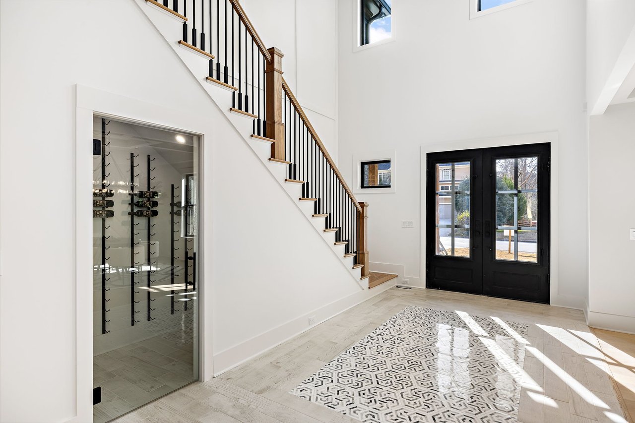 Elegant wine cellar in Ridgewater Bleu luxury home, Marietta GA, featuring custom shelving and potential for wine storage, perfect for wine enthusiasts.
