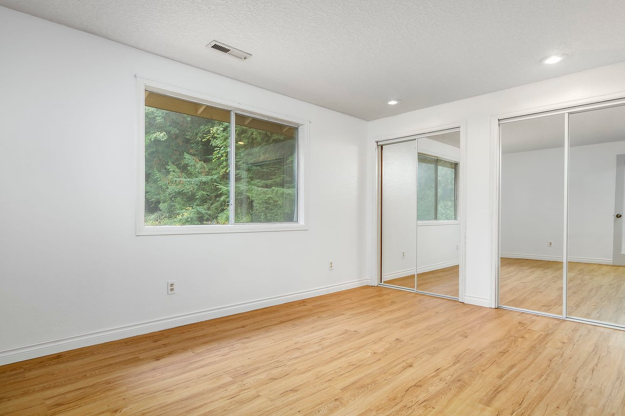 Among the four bedrooms, you'll find another inviting space with ample room, a glass door closet, and large windows, ensuring that every member of the household enjoys a comfortable and well-lit bedroom retreat.