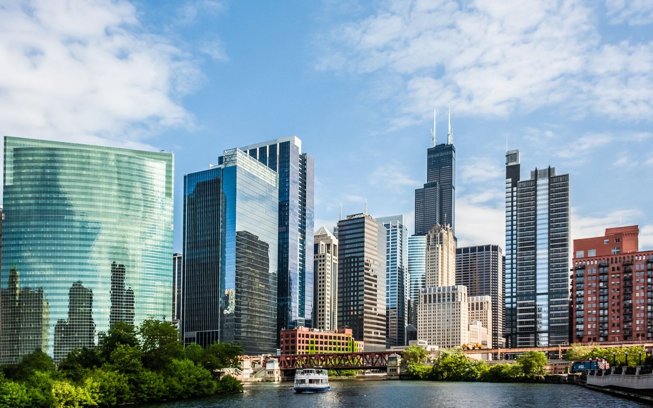 A view of an office building in Chicago's West Loop submarket near the Chicago River, with boats in the foreground.