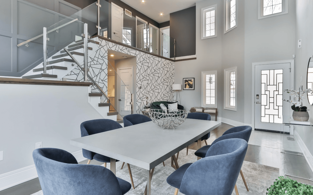 A modern-style dining room with light wood flooring, white walls, a buffet cabinet, a sideboard, a dining table, and chairs.