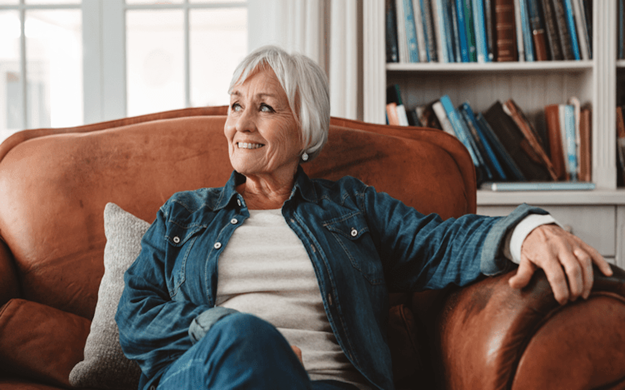 Woman in a blue shirt relaxing in a leather chair.