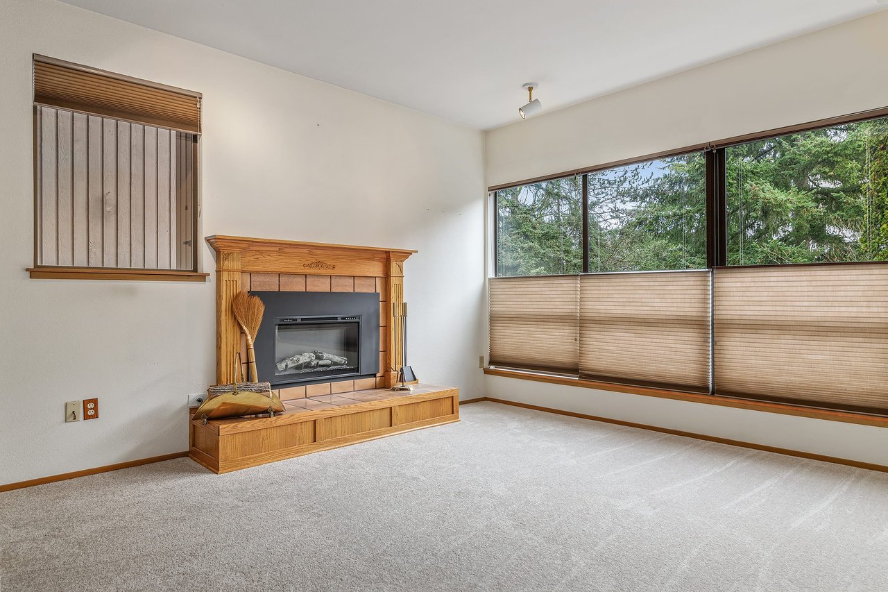 Cozy up by the lovely fireplace and bask in natural light through the large windows adorned with both up and down blinds, creating the perfect ambiance for every moment.