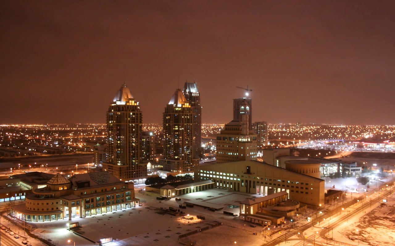 Mississauga skyline at night with lit buildings.