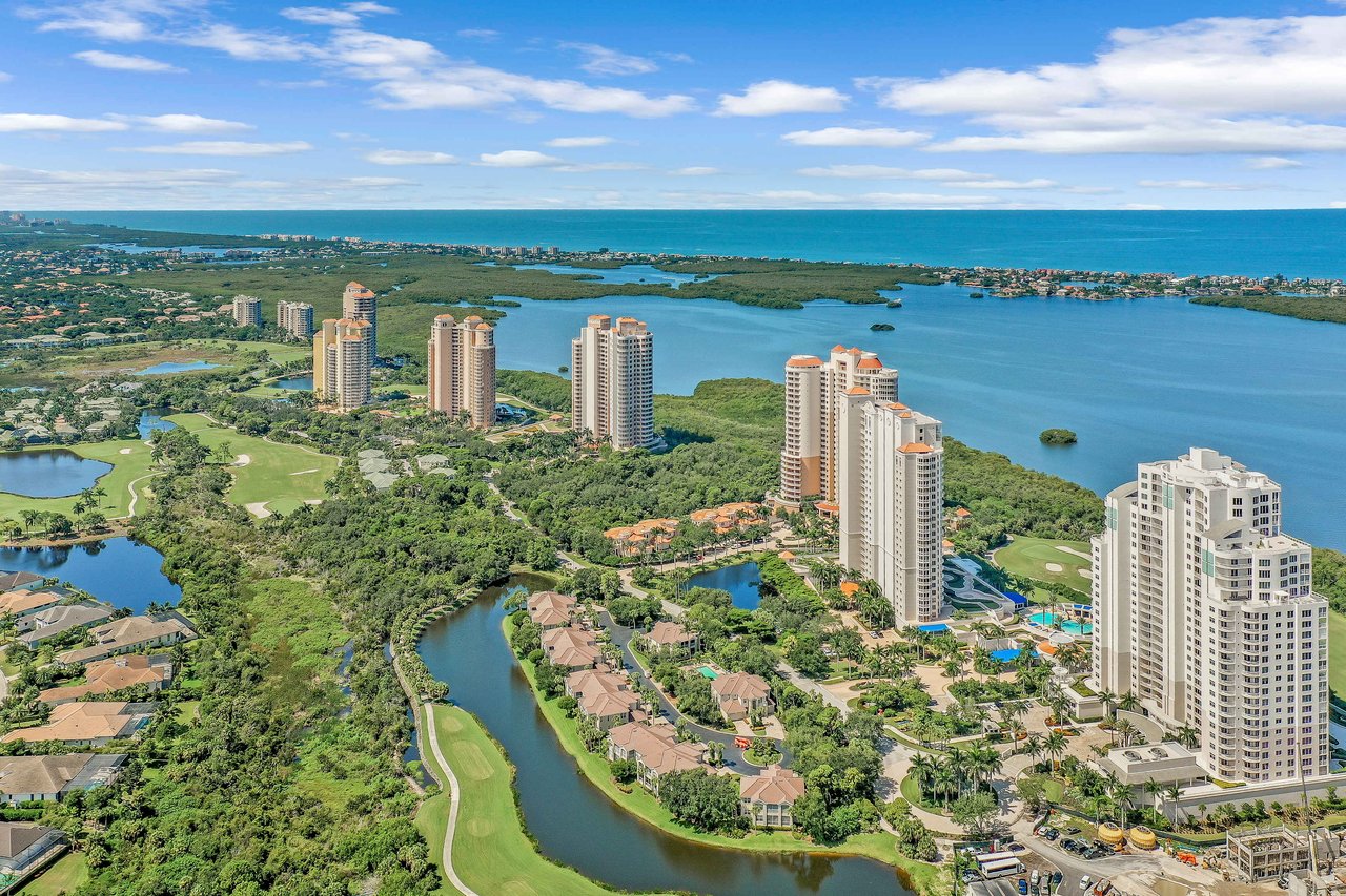  An aerial view of a large residential and golf community on the coast. 