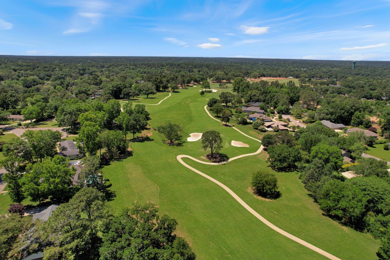 An aerial view of Killearn Estates residential area with a golf course, showing green fairways and surrounding houses.