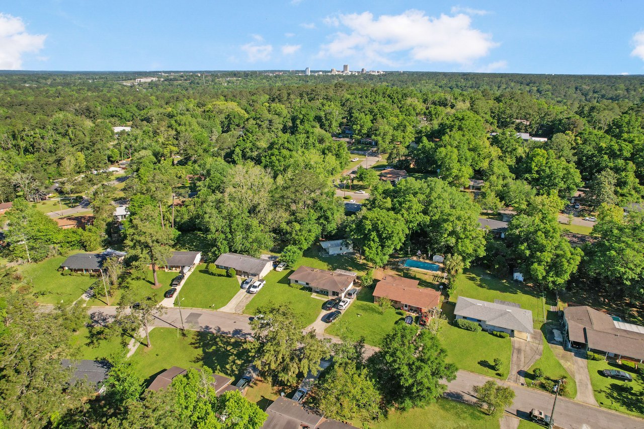 An aerial view focusing on the residential area of Beacon Hill, highlighting houses and surrounding trees.