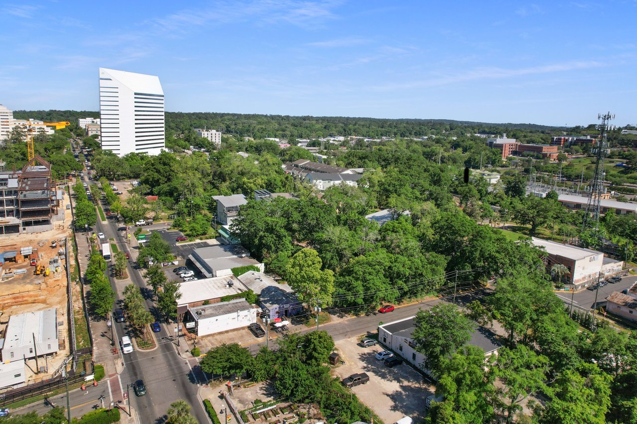 An aerial view of All Saints, emphasizing the mix of residential, commercial, and green spaces within the community.