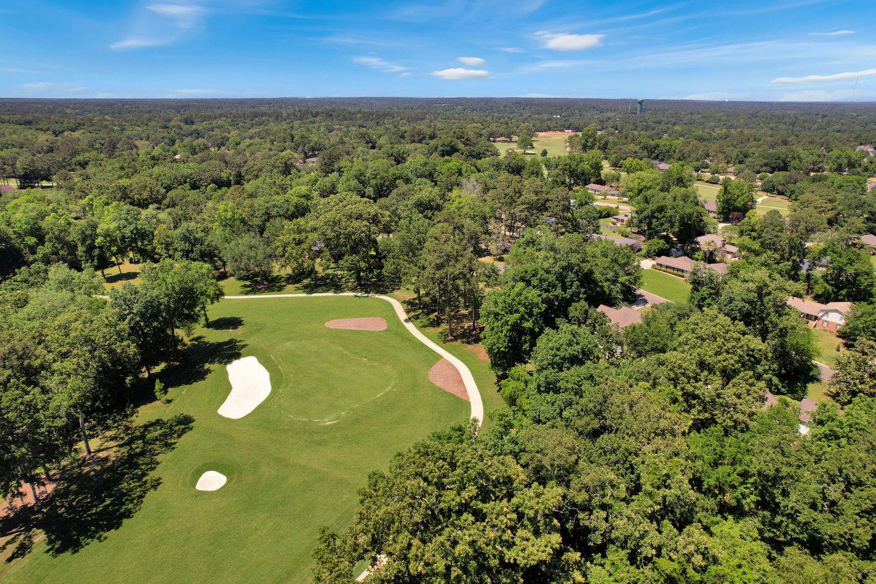 A closer aerial view of a section of the golf course within Killearn Estates, surrounded by trees and homes.
