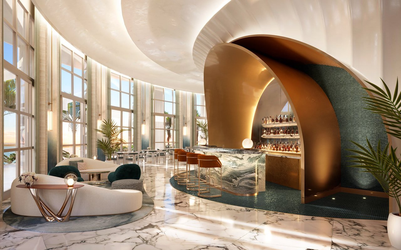 St. Regis Miami Residences lobby lounge with a curved marble bar and bronze arch.