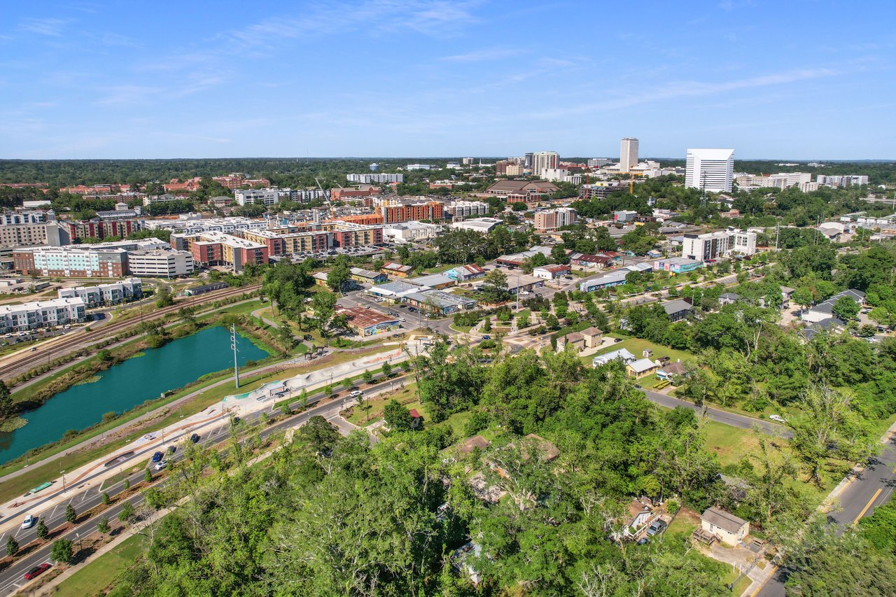 Aerial view of a residential community in Villa Mitchell showing multiple buildings, roads, and green spaces. The area appears to be well-planned and landscaped.